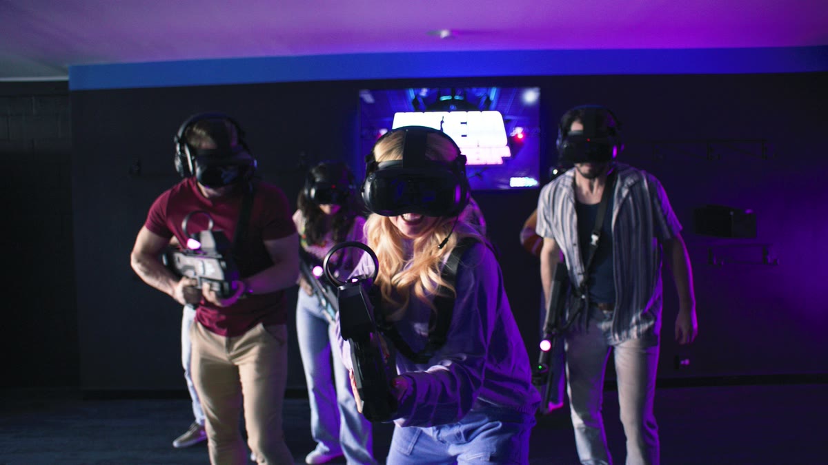 A group of four walking into the Zero Latency free-roam arena together in headsets and gear